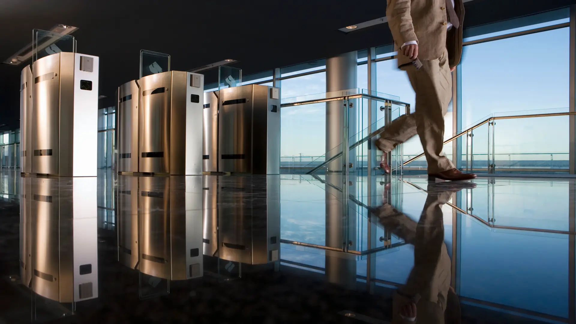 Businessman walking away from office with access control