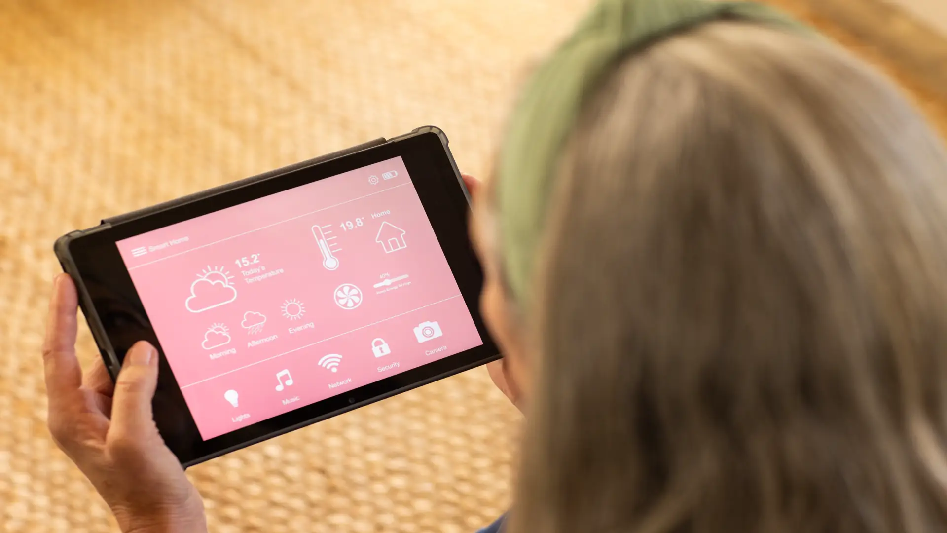 Woman managing smart home settings on tablet