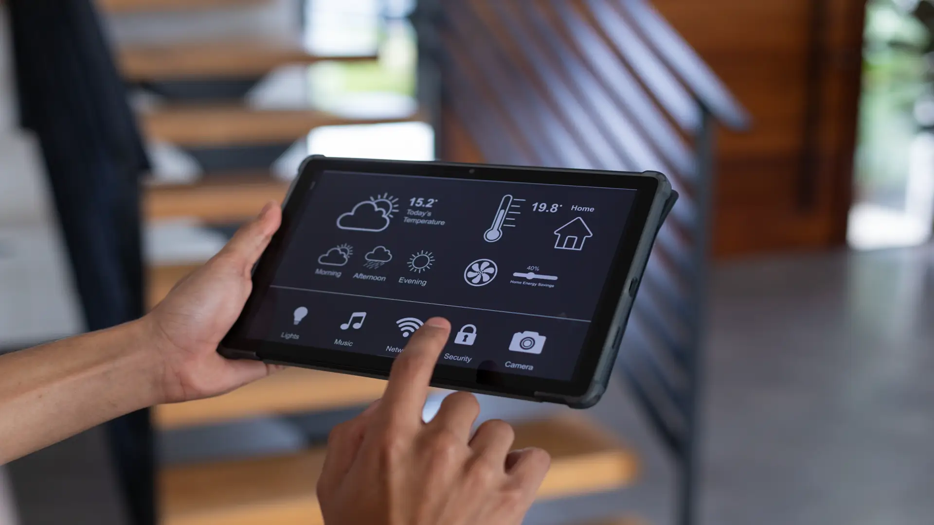 Hands of man using tablet with smart home