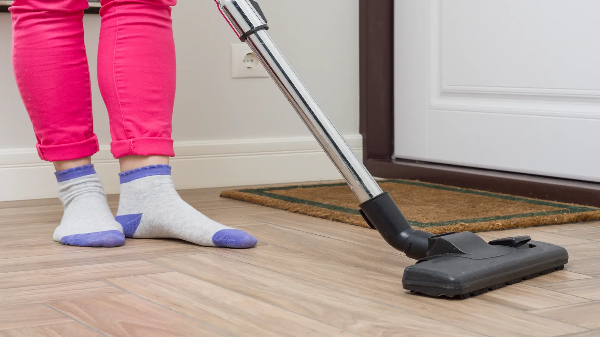 House cleaning woman using vacuum cleaner