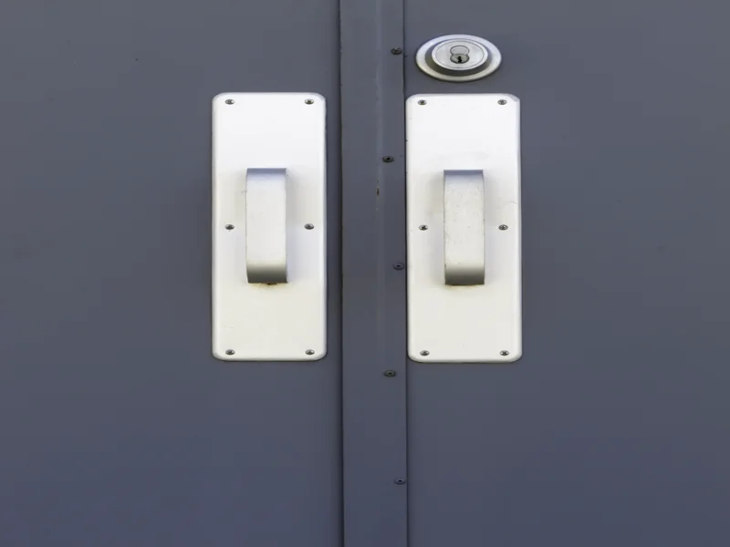 Pair of silver doorhandles and keylock on exterior door