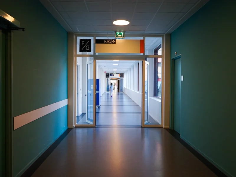 Empty hospital hallway with doors