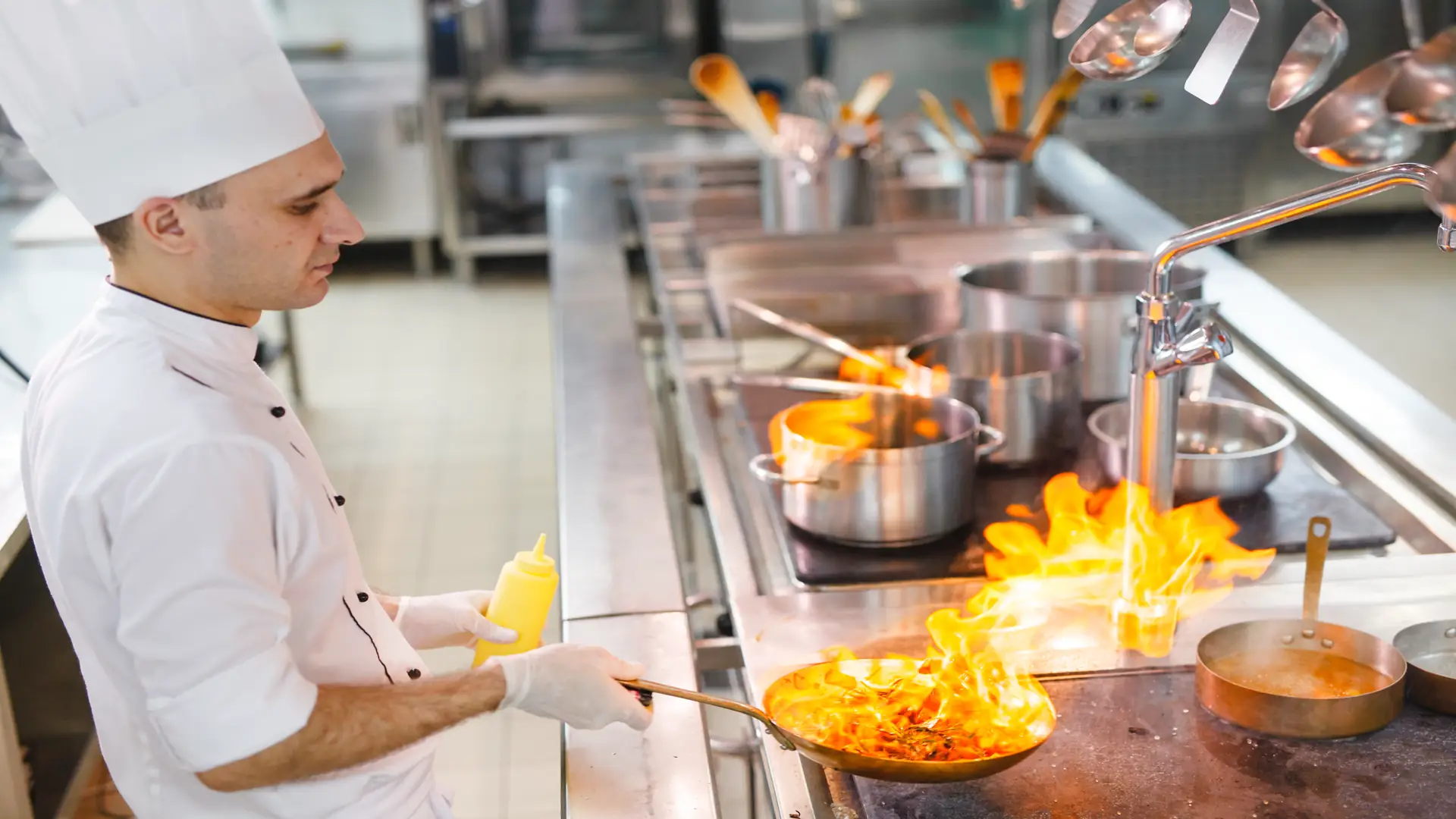 Cooks preparing food in restaurant kitchen