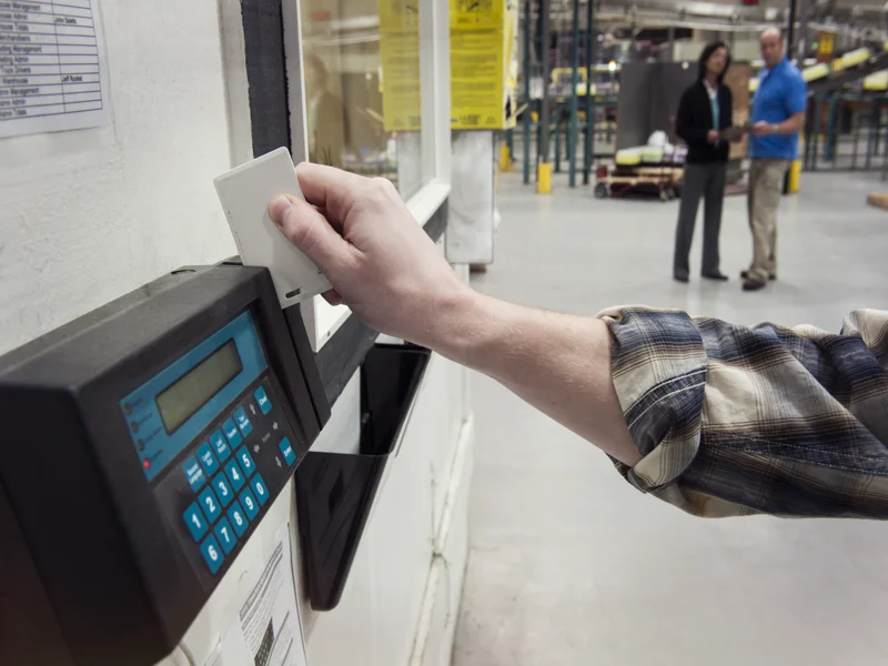 Worker clocking in at factory time clock