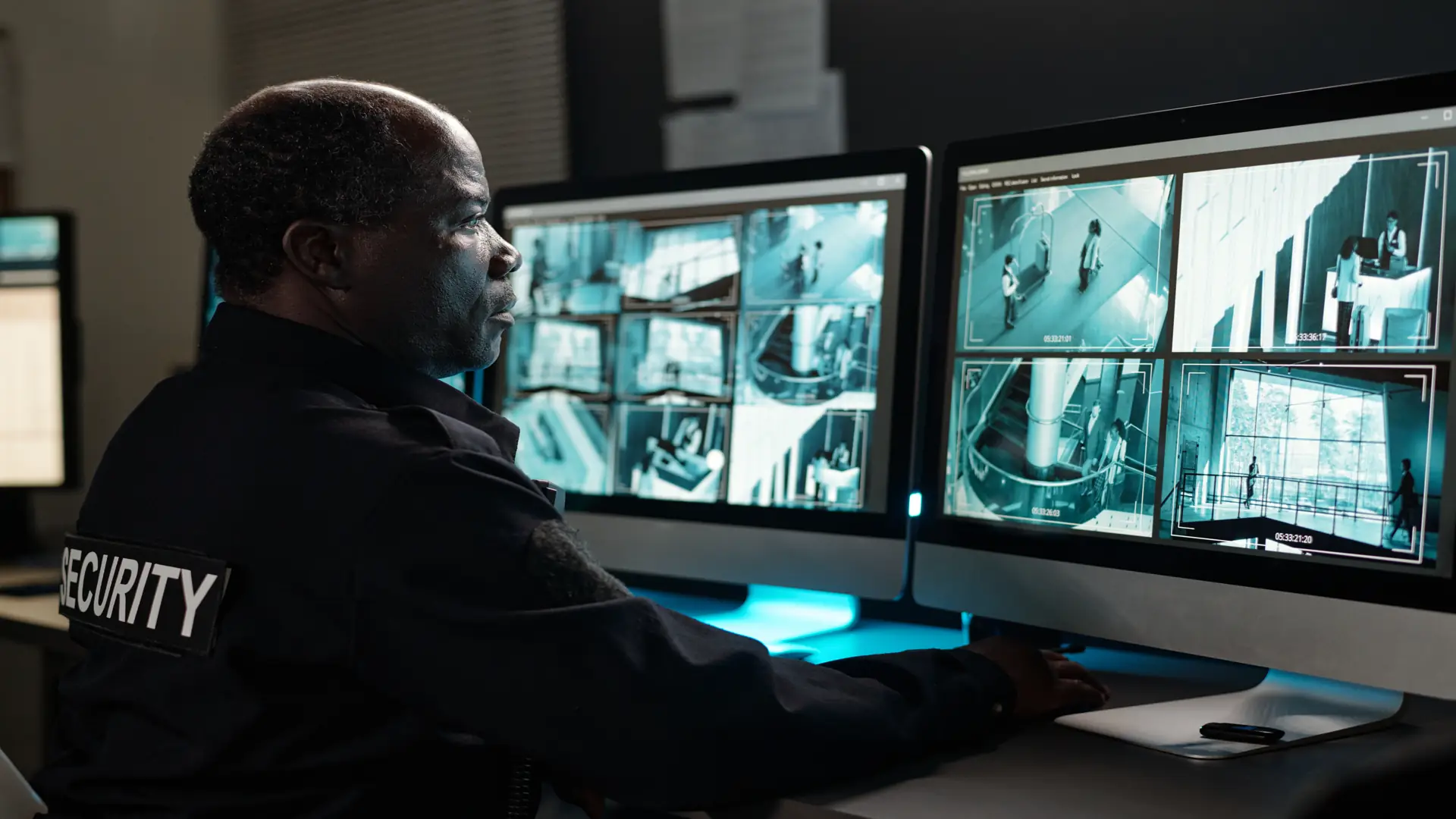 Security operator concentrating on watching CCTV video monitors