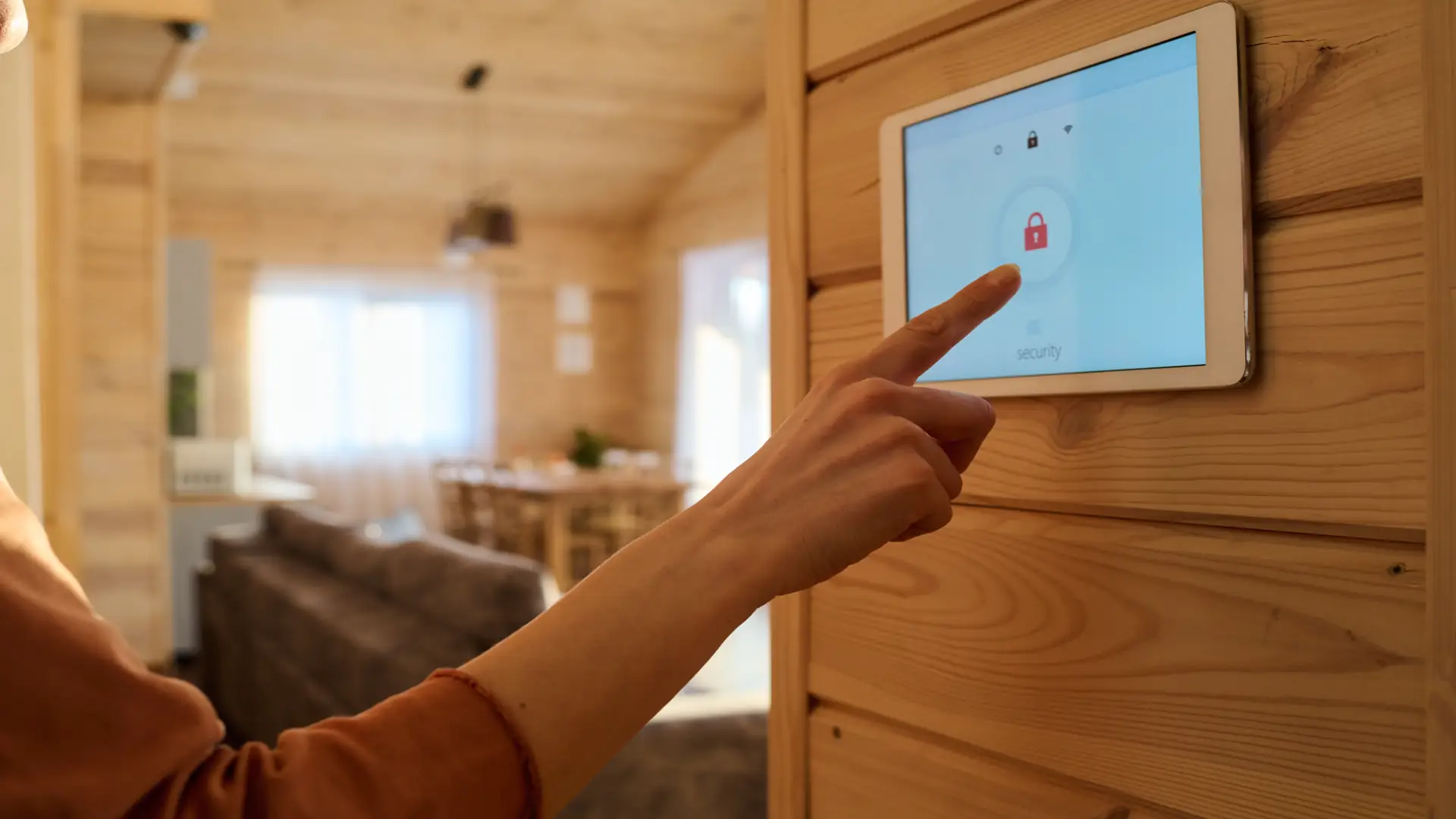 Woman pointing at smart home security panel screen
